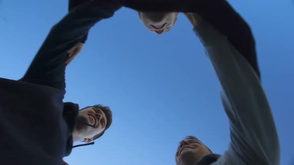 Friends Jumping Together, Chanting Slogan of Victory, Teamwork, Bottom View alt