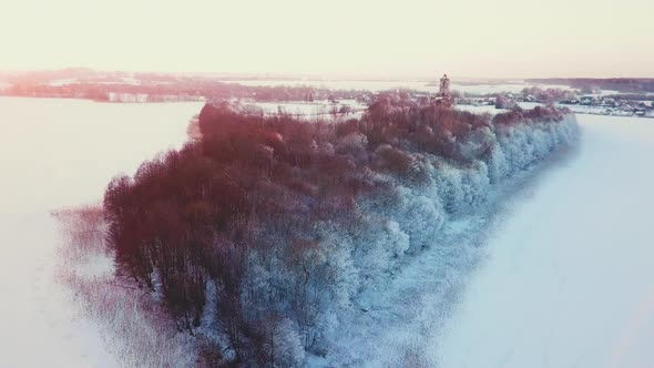 a Forest Island with a Church in the Middle of a Frozen Lake