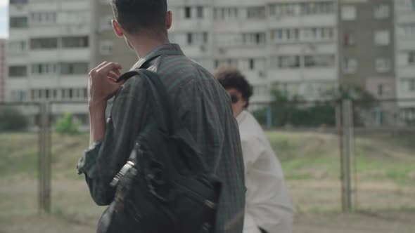 Side View of Laughing 1990s Men Having Fun As Walking Outdoors in City. Portrait of Positive alt