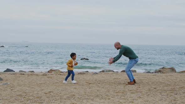 Daddy Is Playing With Son On Beach