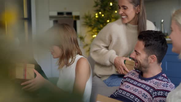 Woman receiving sweater as Christmas present. Shot with RED helium camera in 8K alt