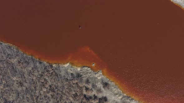 Red acidic water laden with iron sulfate  and other metals 4K aerial video alt