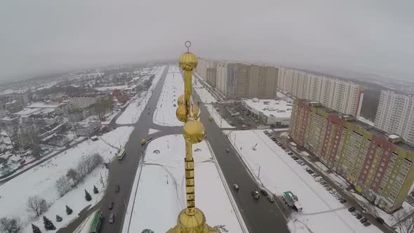 Golden cross on the church in city, aerial view alt