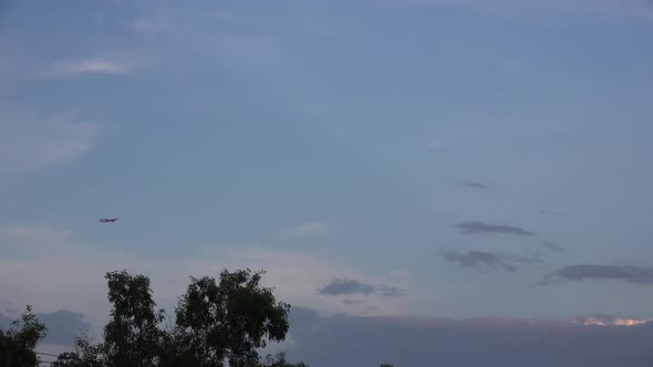 An airplane flies across a blue sky.