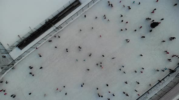 A Lot of People Skate on the Ice Rink in Open Street alt