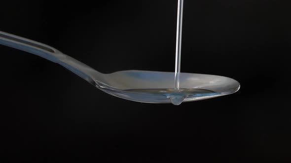 Oil Pouring On Spoon alt
