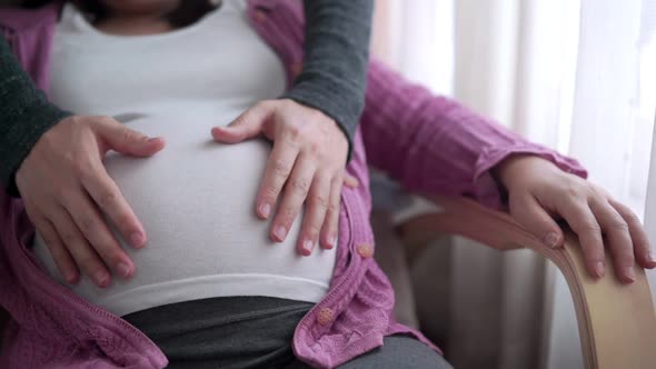 Pregnant Couple Feels Love and Relax at Home alt