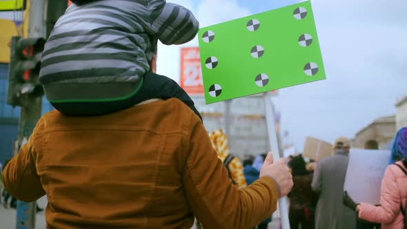 Family of Father and Son at Rally with Blank Chromakey Space Mockup Banner alt