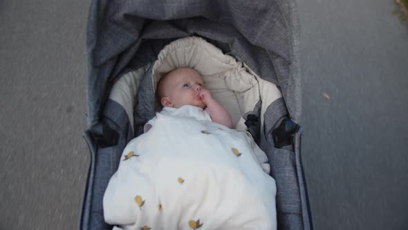 Cute Video of Baby Girl Thumbsucking on a Moving Stroller alt