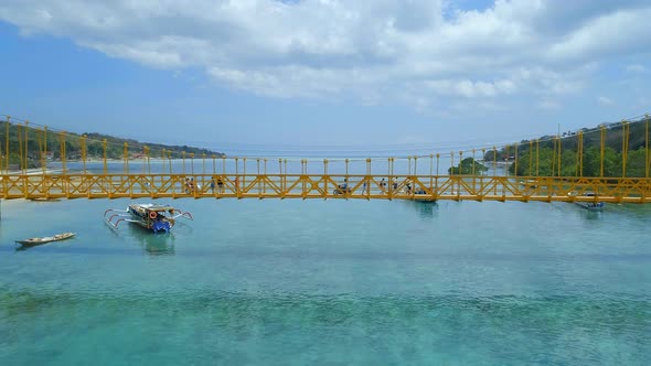 Vehicles Using The Yellow Bridge Connecting Nusa Lembongan and Cennigan Islands alt