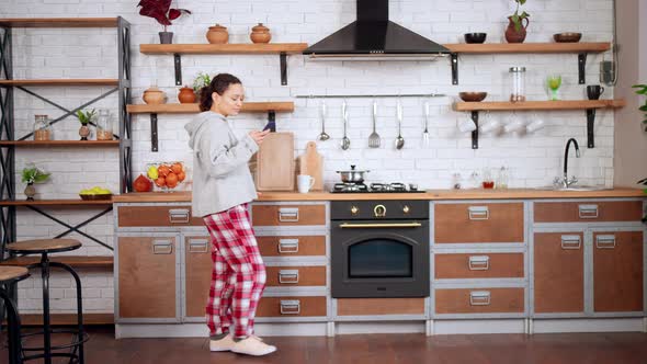 Happy Female Using Mobile in Apartment