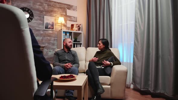 Back View of Psychotherapist Counseling Young Husband and Wife alt