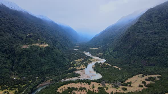 Aerial view truck left in the Cochamo Valley on a cloudy day. Cochamo River between mountains. alt