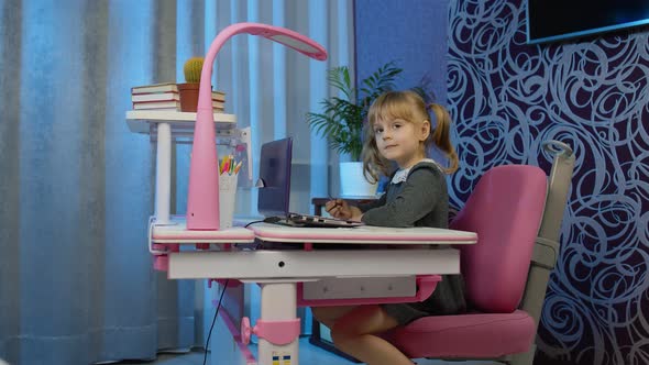 Cute Kid Pupil Watching Video Lesson Studying Using Digital Laptop Computer Doing Homework Online alt