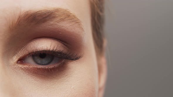 Studio portrait of young, beautiful and natural woman over grey background. alt