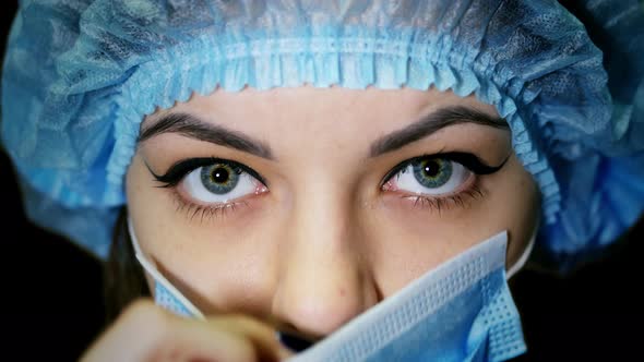 Portrait of a Female Doctor, Puts on Surgical Mask, Prepare for Surgery alt