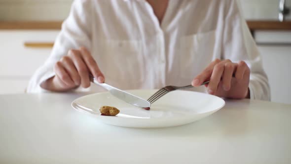 Large White Plate With One Peanut. Knife And Fork. I'll Eat A Tiny Nut! Weight Loss Concept alt