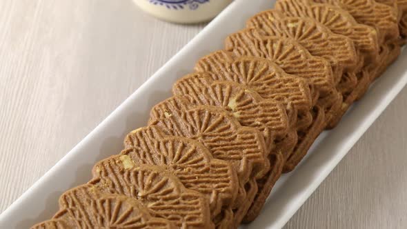 Traditional fresh baked Dutch cookies called speculaas in the shape of a windmill close up alt