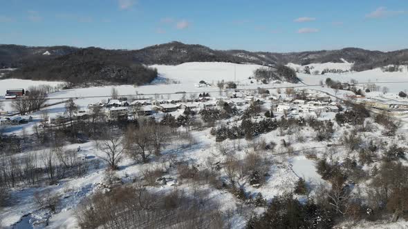 Fast motion of winter wonderland through Wisconsin valley and snow covered mountains.