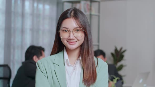 Portrait Of Young Asian Business Woman Standing With Folded Arms At Office alt