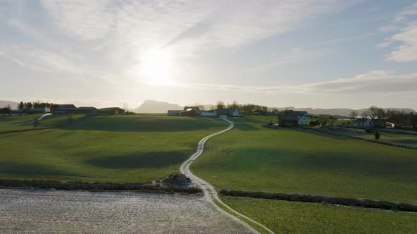 Rural Scenery With Sun Flooded Farm Land Property In Norway, Aerial alt