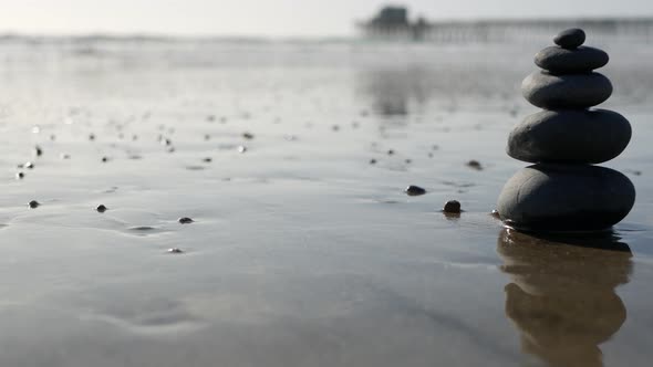 Rock Balancing on Ocean Beach Stones Stacking By Sea Water Waves