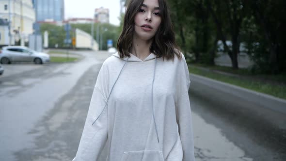 Video of a Beautiful Young Girl of Asian Appearance Walks Around the City