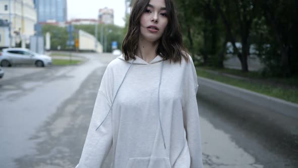 Video of a Beautiful Young Girl of Asian Appearance Walks Around the City alt