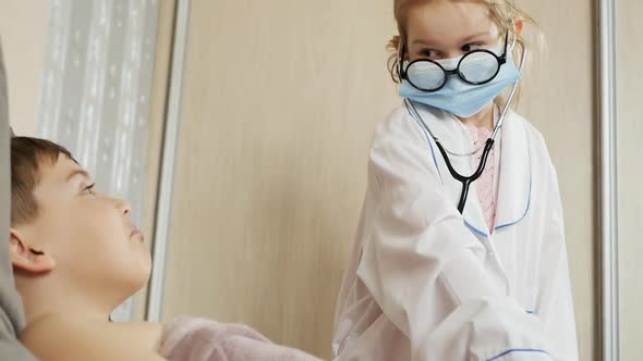 Teenagers Boy and Girl Play Doctor and Patient in the Bedroom, Stock Footage     