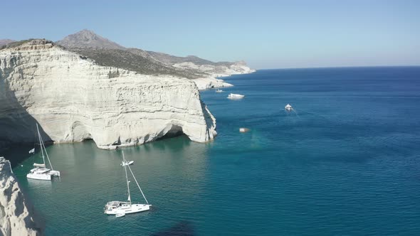 Aerial View of Tropical Island with White Rocks and Boats in Bay  alt