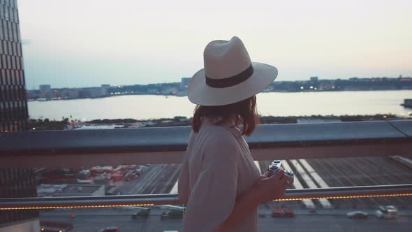 Attractive young girl with a retro camera in the Wessel building in New York City alt