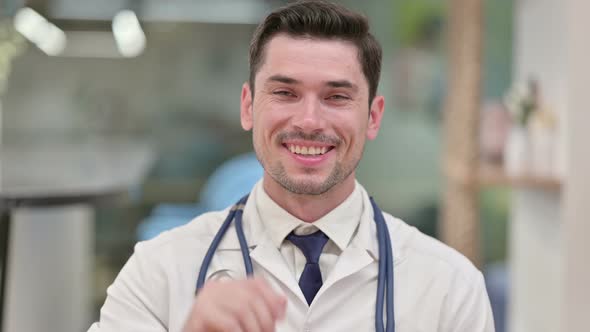 Friendly Young Male Doctor Talking on Video Call  alt