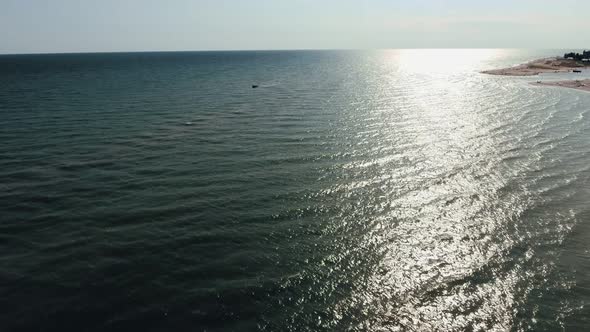 Aerial Shot of Beautiful Sun Path on the Black Sea Waves at Sunset in Summer alt