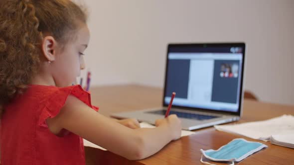 Distance Learning Online Education Schoolgirl Sits at Home at Her Desk Performs a School Assignment alt