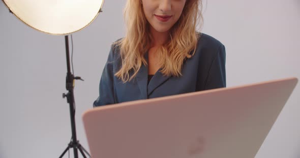 Girl Working On A Laptop In The Studio On A White Background