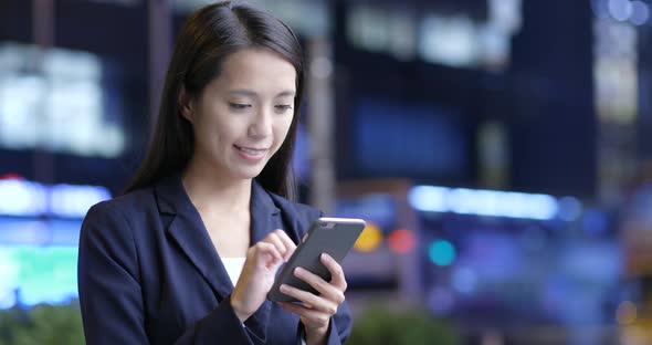 Businesswoman Use of Smart Phone in Hong Kong City at Night