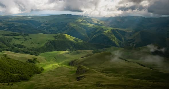 Low Clouds Over a Highland Plateau in the Rays of Sunset alt