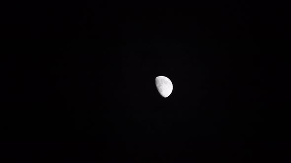 Time lapse: the moon floating in night black sky alt