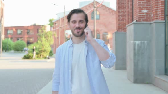 Walking Man Using Smartphone Slow Motion alt