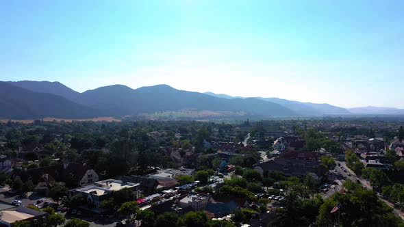 Drone shot of the mountains and city of Solvang Ca. alt