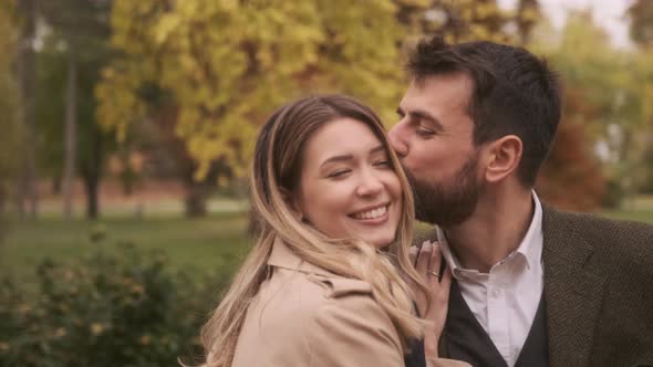 Handsome young couple walking in the autumn park