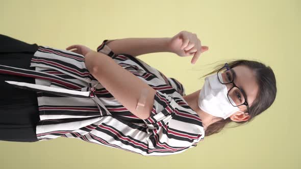 Vertical Video of Young Woman Showing COVID19 Vaccine Bandage Merrily alt