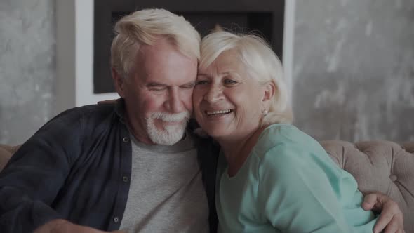 Happy Smiling Senior Couple Embracing Together at Home alt