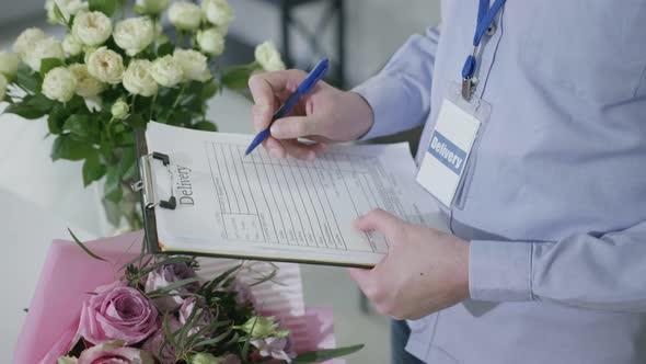 Delivery, Closeup Hands of Man Checking Order Form for Delivery of Bouquets From Flower Shop, Small alt