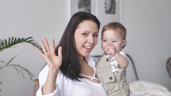 Portrait of Happy Family Young Mother and Toddler Baby Boy Looking at Camera alt