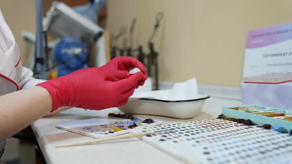 Ophthalmologist or surgeon holds an eye, eyeball prosthesis in hands.  alt