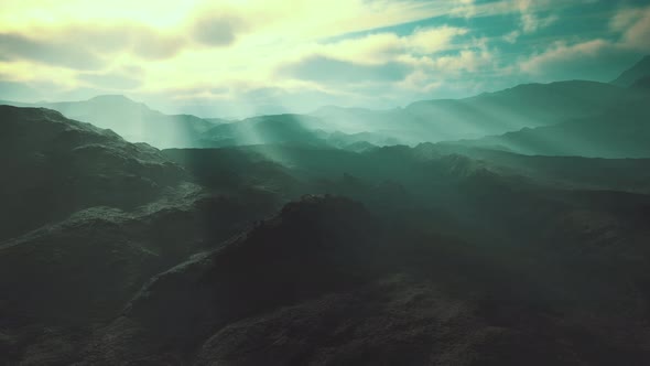Black Volcanic Dust and Mountains with Fog in Background alt