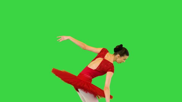Young Ballerina in Red Classical Tutu Walks Demipointe and Makes Arms Movements on a Green Screen