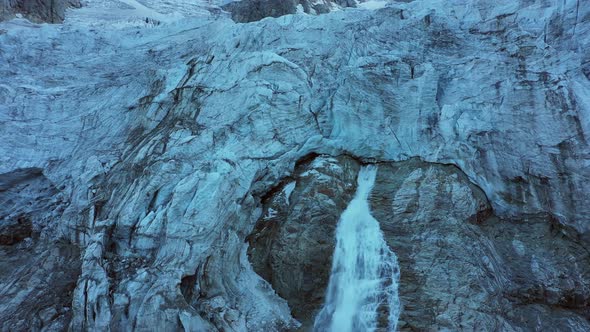 Flying Over the Waterfall Below the Glacier. Aerial View 