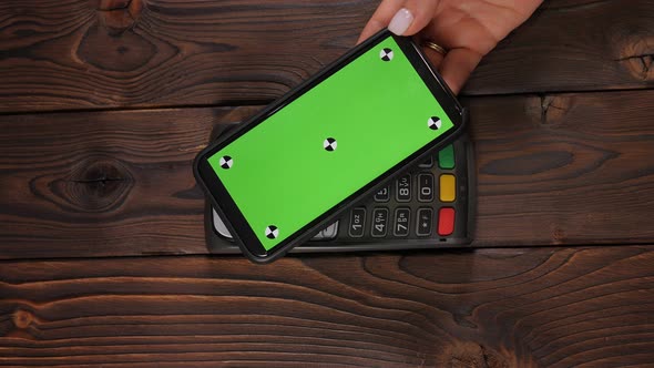 Closeup a Smartphone with Green Screen Template with an NFC Payment Technology alt